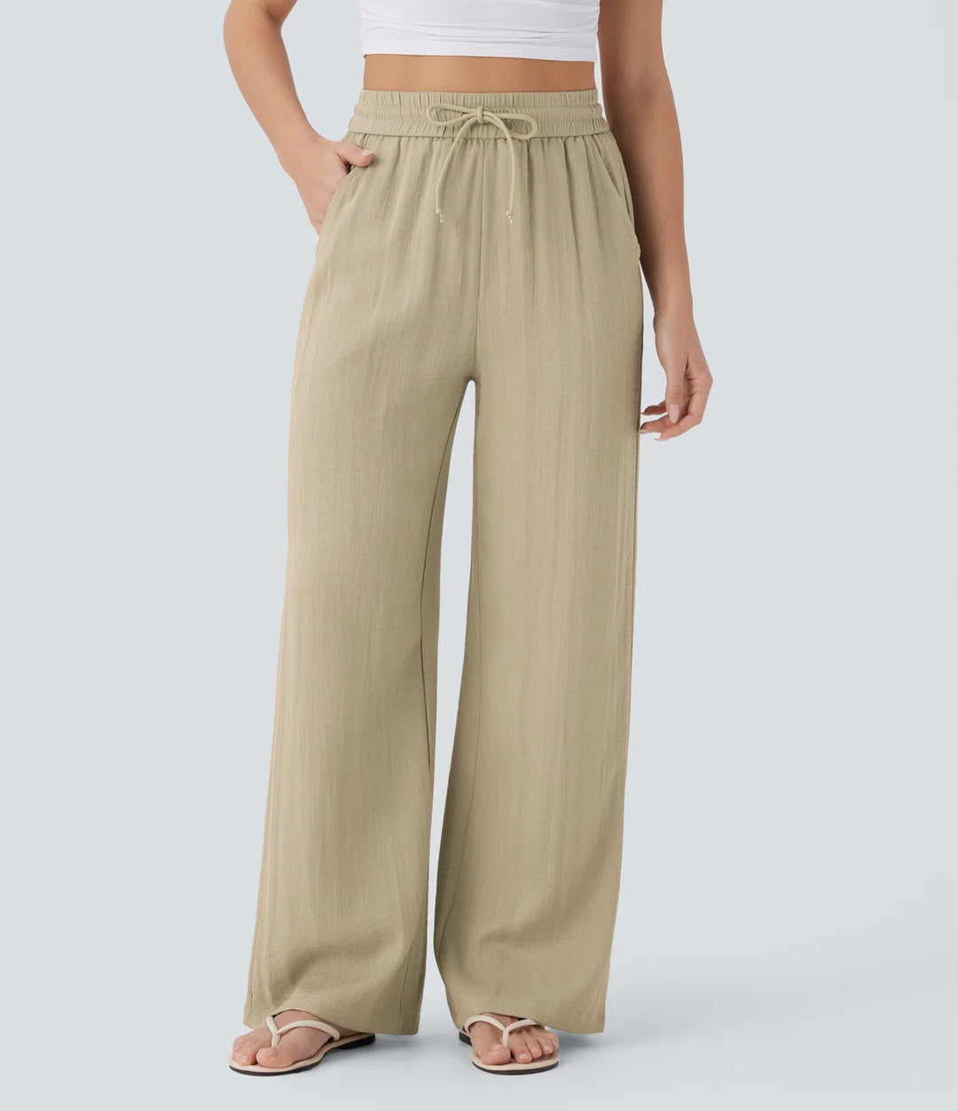 Pantalon large fluide taille haute avec cordon de serrage, poches latérales et aspect lin