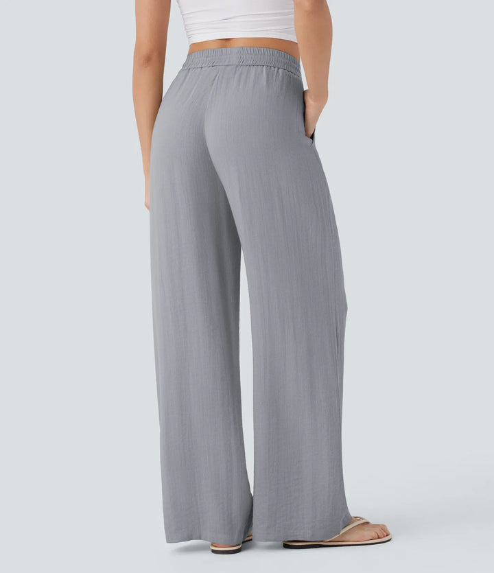 Pantalon large fluide taille haute avec cordon de serrage, poches latérales et aspect lin