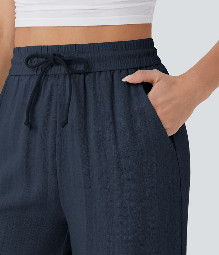 Pantalon large fluide taille haute avec cordon de serrage, poches latérales et aspect lin