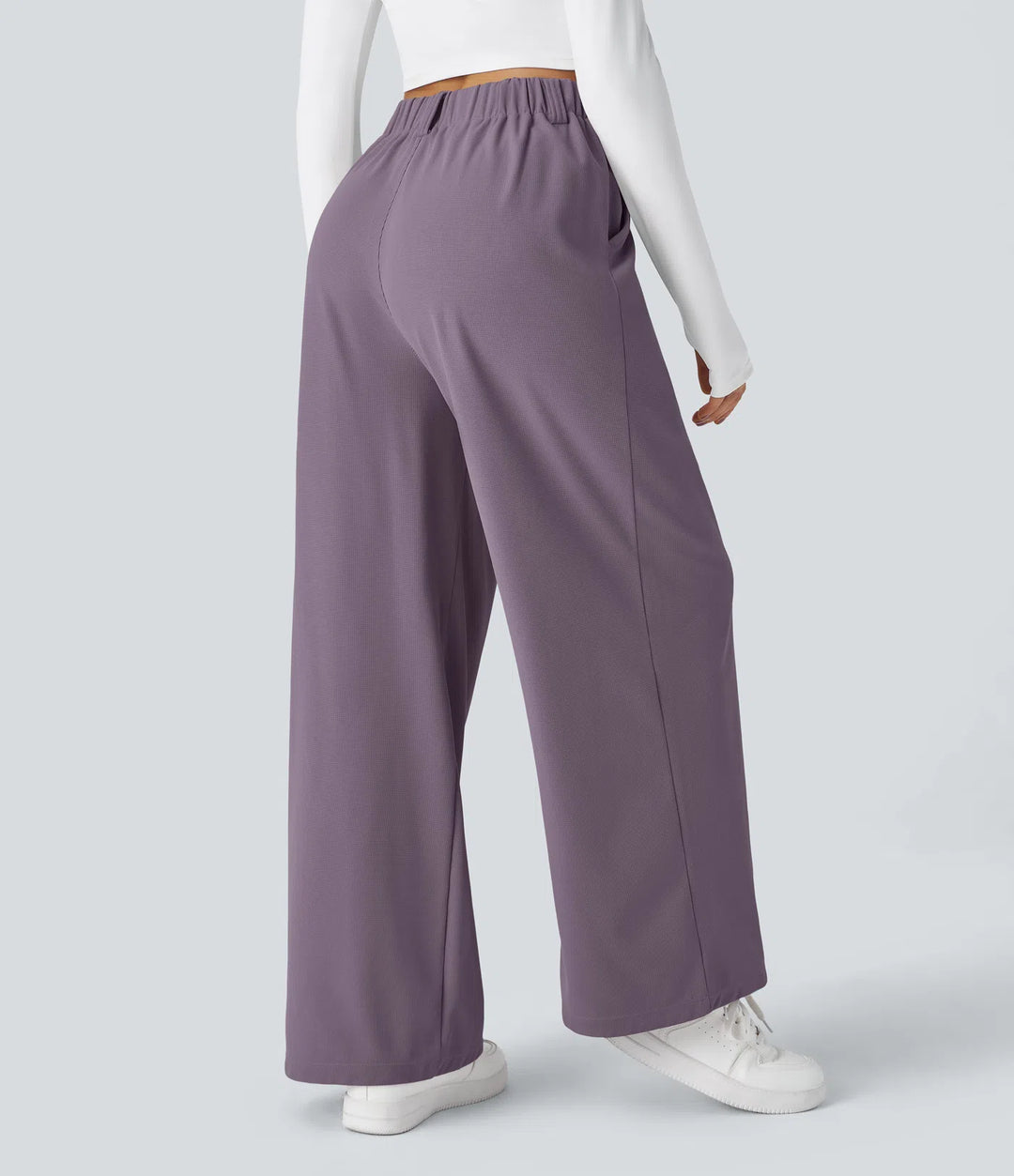 Pantalon fluide à taille haute et jambes larges, en tissu gaufré, avec poches latérales