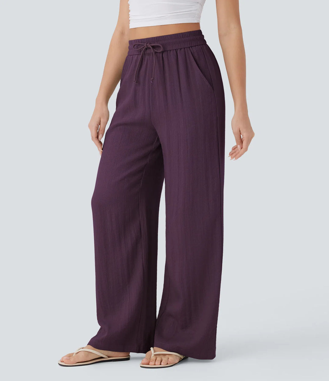 Pantalon large fluide taille haute avec cordon de serrage, poches latérales et aspect lin