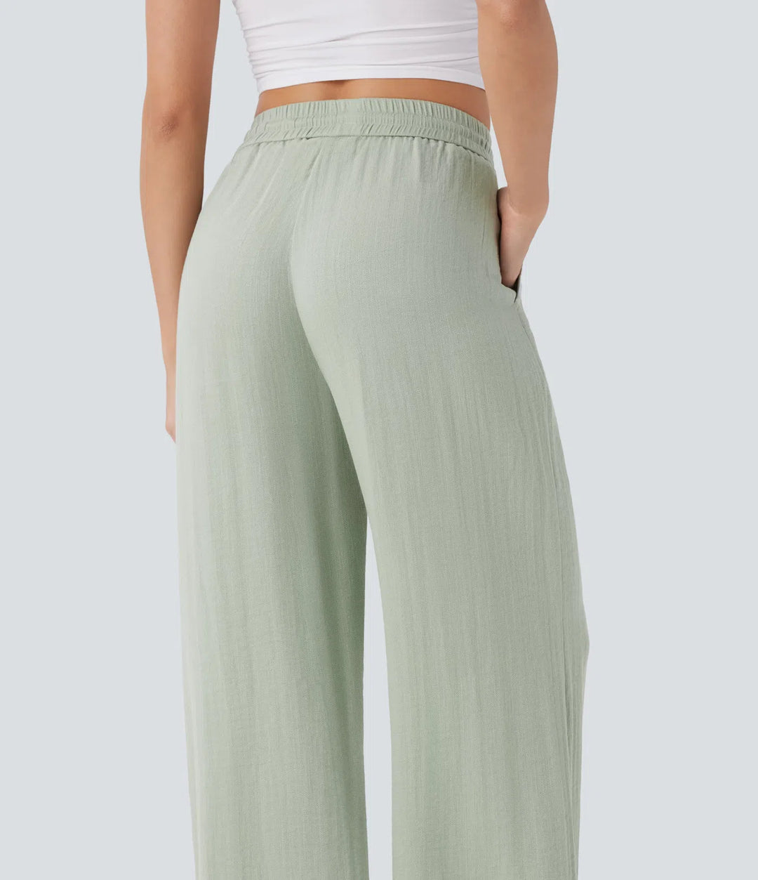 Pantalon large fluide taille haute avec cordon de serrage, poches latérales et aspect lin