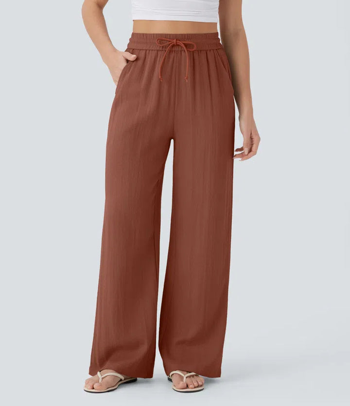 Pantalon large fluide taille haute avec cordon de serrage, poches latérales et aspect lin