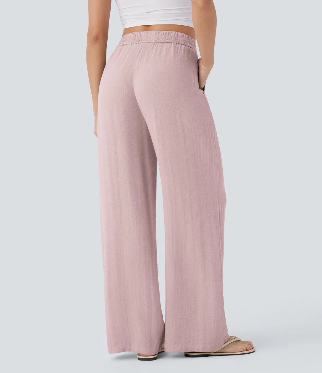 Pantalon large fluide taille haute avec cordon de serrage, poches latérales et aspect lin