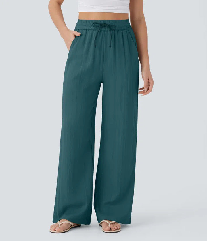 Pantalon large fluide taille haute avec cordon de serrage, poches latérales et aspect lin