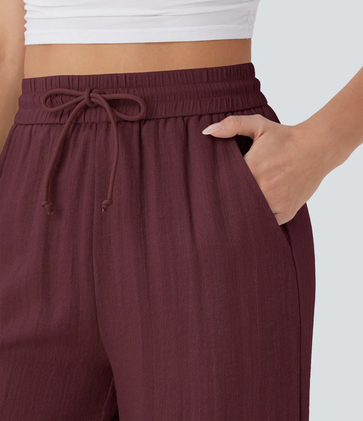 Pantalon large fluide taille haute avec cordon de serrage, poches latérales et aspect lin