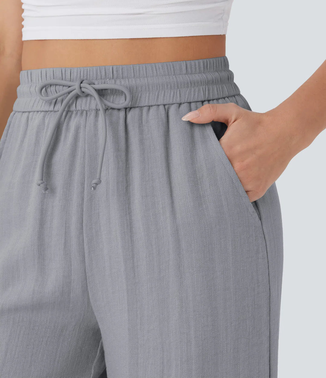 Pantalon large fluide taille haute avec cordon de serrage, poches latérales et aspect lin