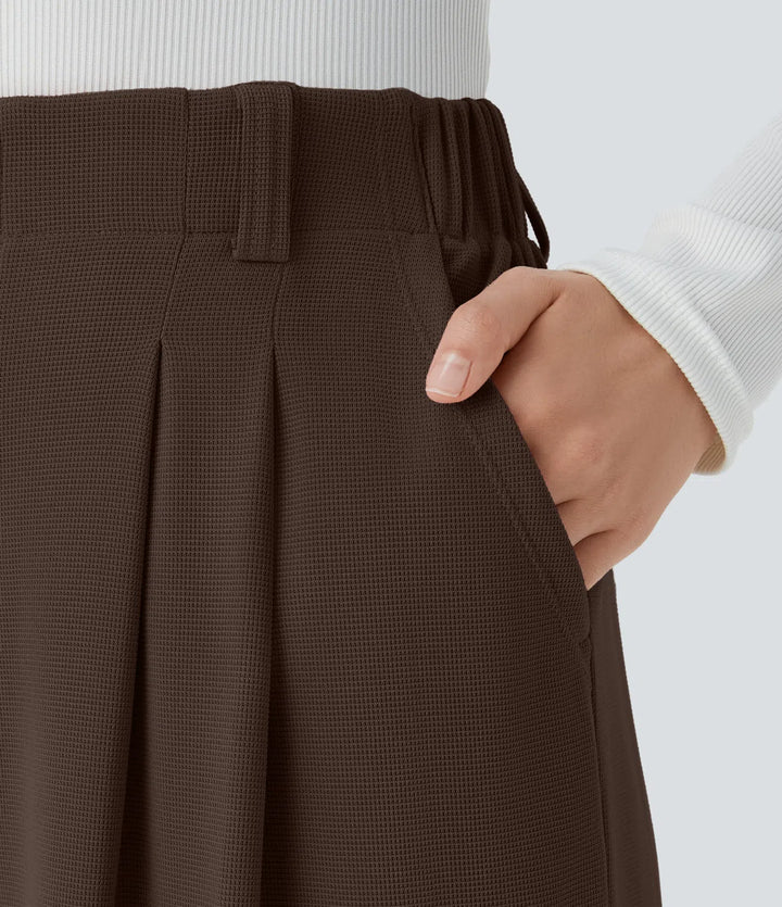 Pantalon fluide à taille haute et jambes larges, en tissu gaufré, avec poches latérales