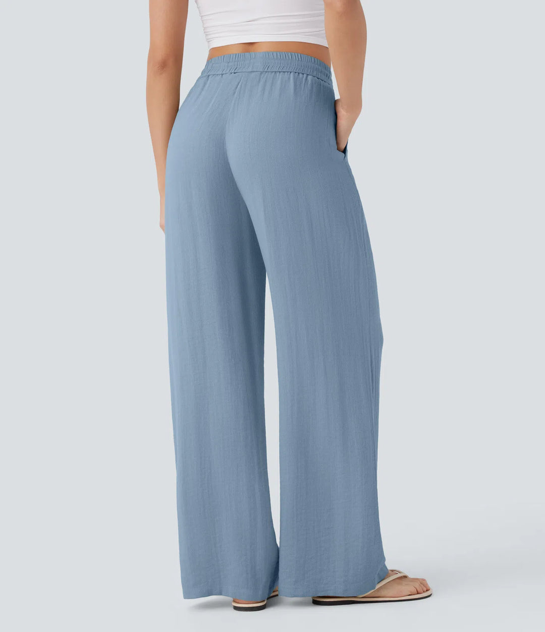 Pantalon large fluide taille haute avec cordon de serrage, poches latérales et aspect lin