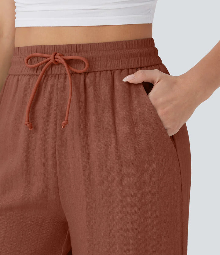 Pantalon large fluide taille haute avec cordon de serrage, poches latérales et aspect lin