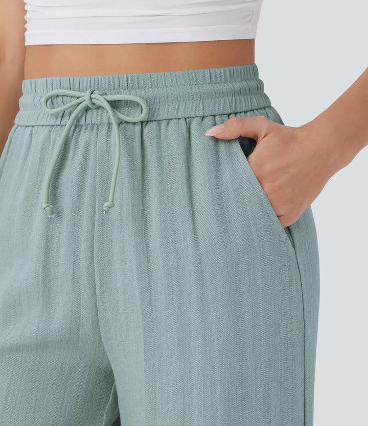 Pantalon large fluide taille haute avec cordon de serrage, poches latérales et aspect lin