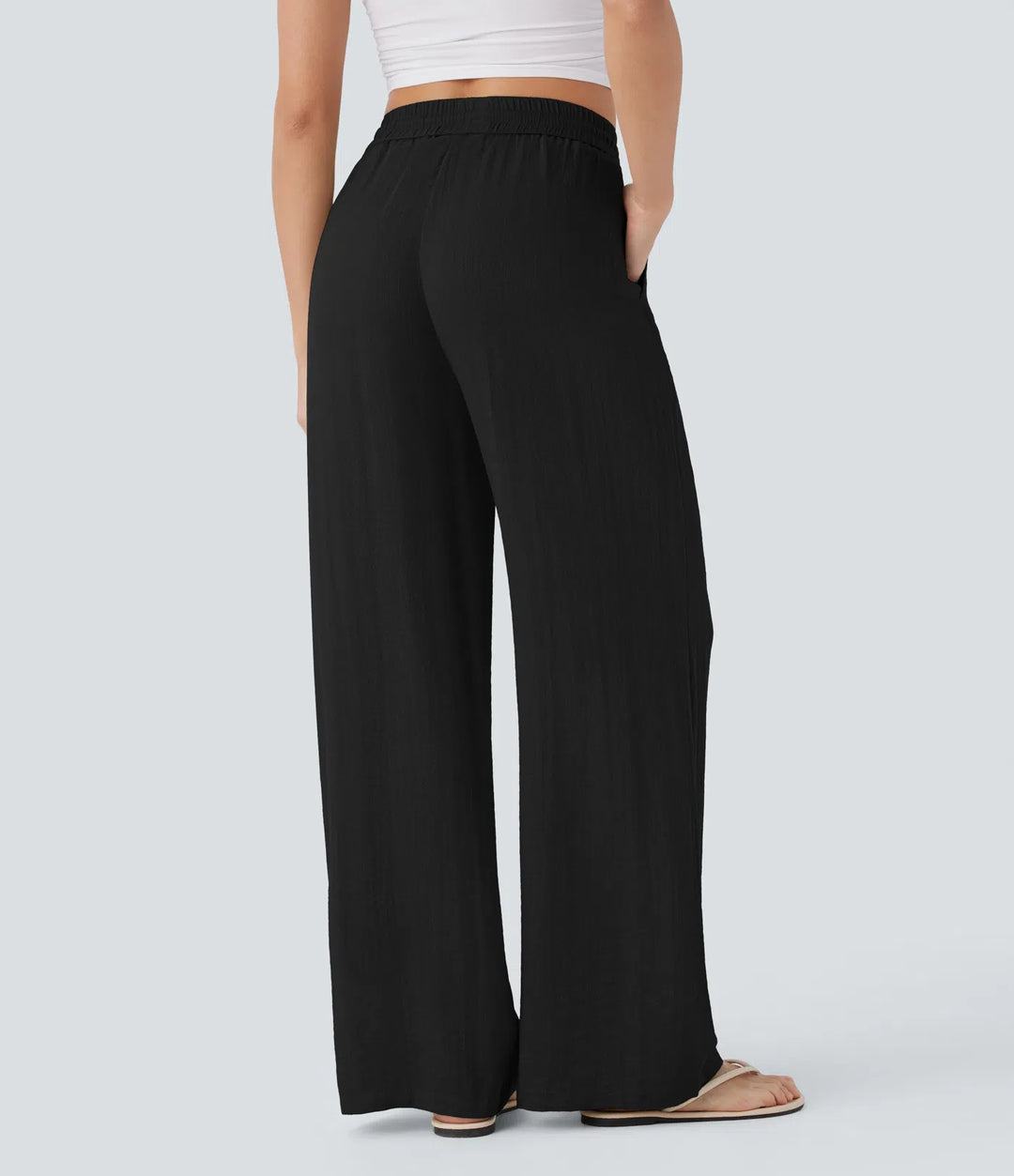 Pantalon large fluide taille haute avec cordon de serrage, poches latérales et aspect lin