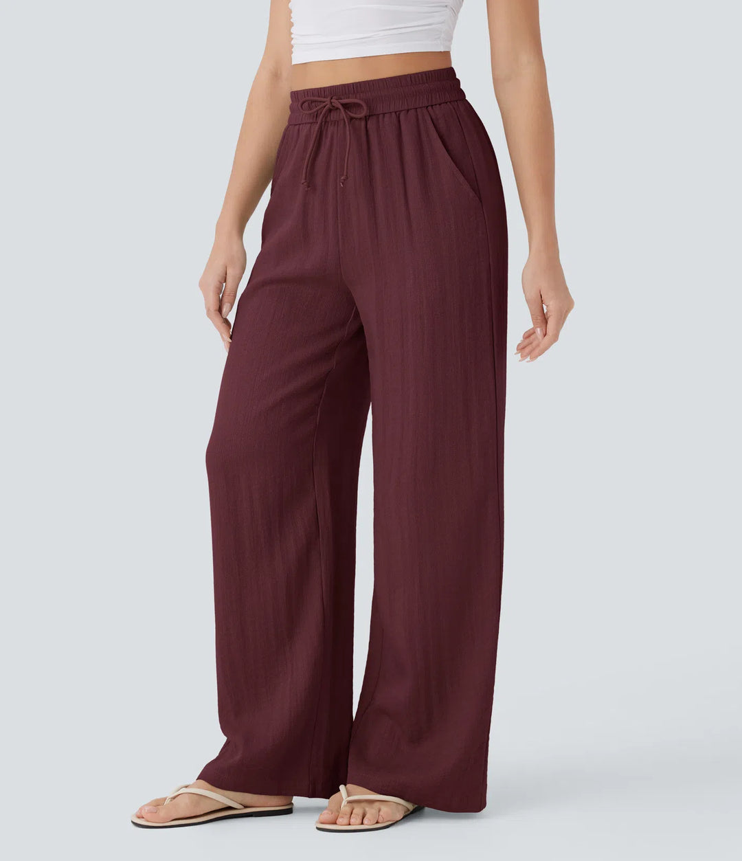 Pantalon large fluide taille haute avec cordon de serrage, poches latérales et aspect lin