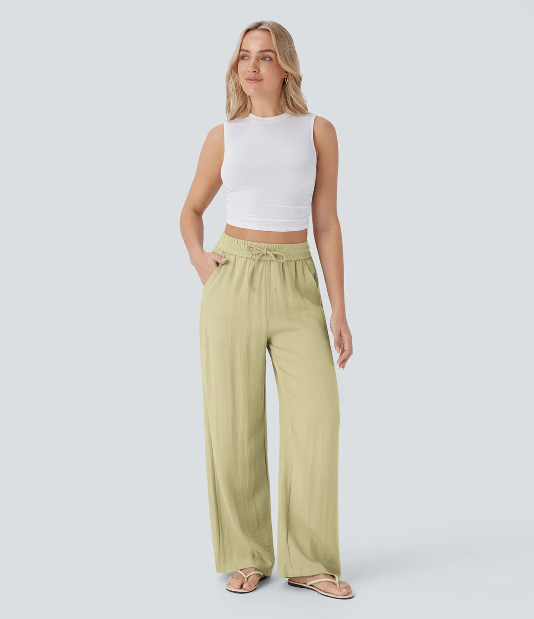 Pantalon large fluide taille haute avec cordon de serrage, poches latérales et aspect lin