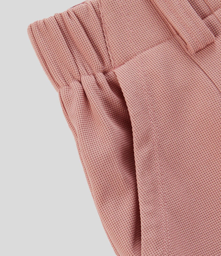 Pantalon fluide à taille haute et jambes larges, en tissu gaufré, avec poches latérales
