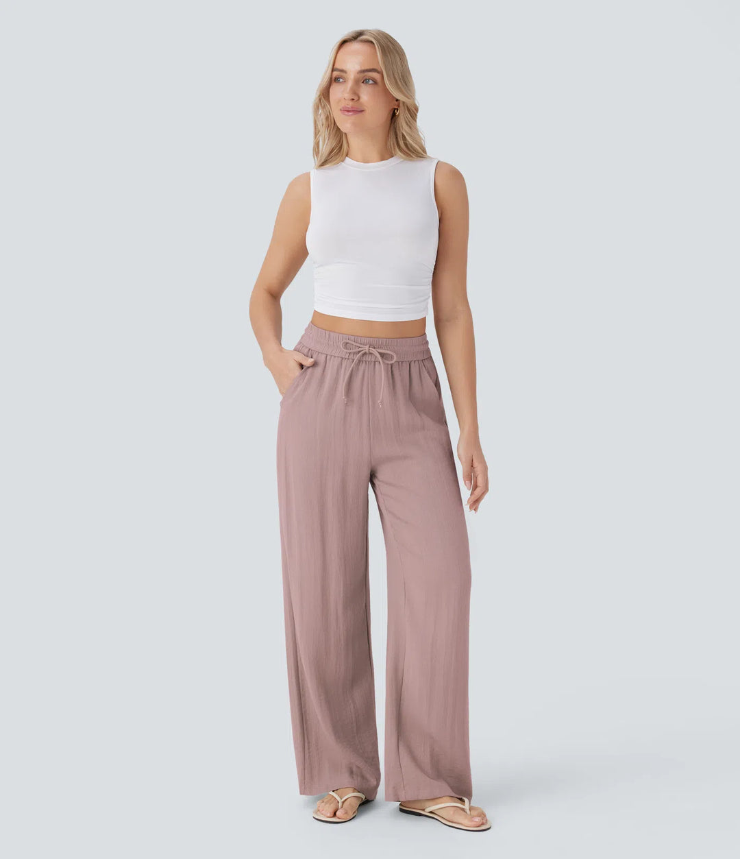 Pantalon large fluide taille haute avec cordon de serrage, poches latérales et aspect lin