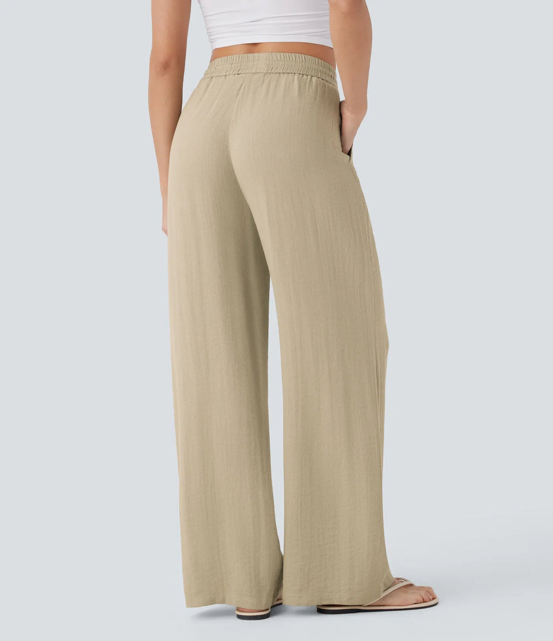 Pantalon large fluide taille haute avec cordon de serrage, poches latérales et aspect lin