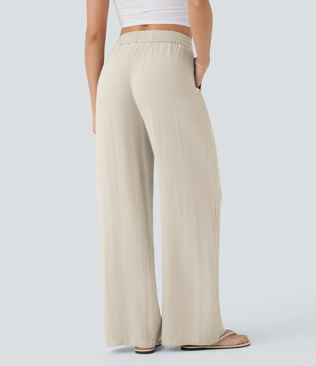 Pantalon large fluide taille haute avec cordon de serrage, poches latérales et aspect lin