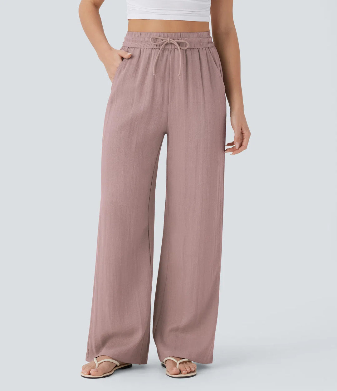 Pantalon large fluide taille haute avec cordon de serrage, poches latérales et aspect lin