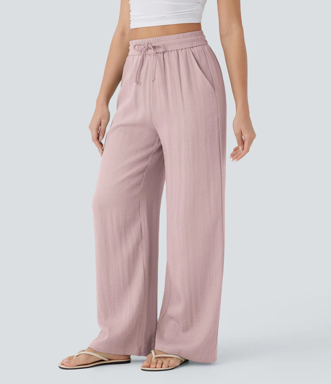 Pantalon large fluide taille haute avec cordon de serrage, poches latérales et aspect lin