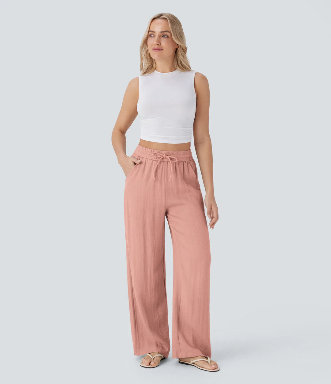 Pantalon large fluide taille haute avec cordon de serrage, poches latérales et aspect lin