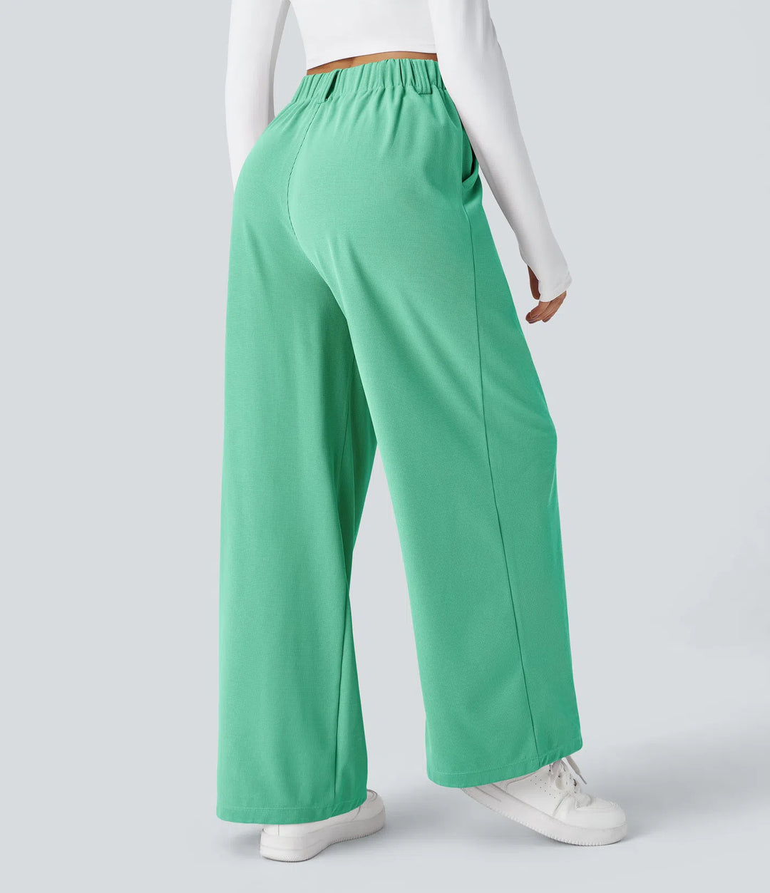 Pantalon fluide à taille haute et jambes larges, en tissu gaufré, avec poches latérales